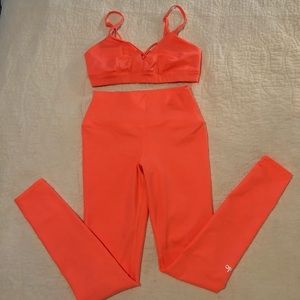 ALO Yoga leggings and bra set in orange sherbet